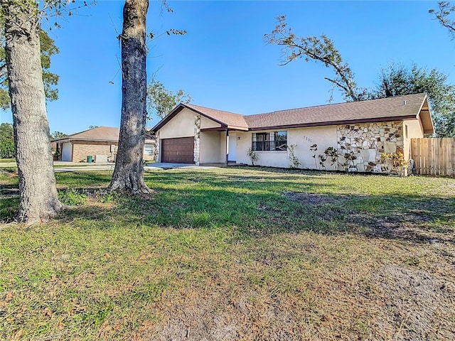 single story home featuring a front yard and a garage