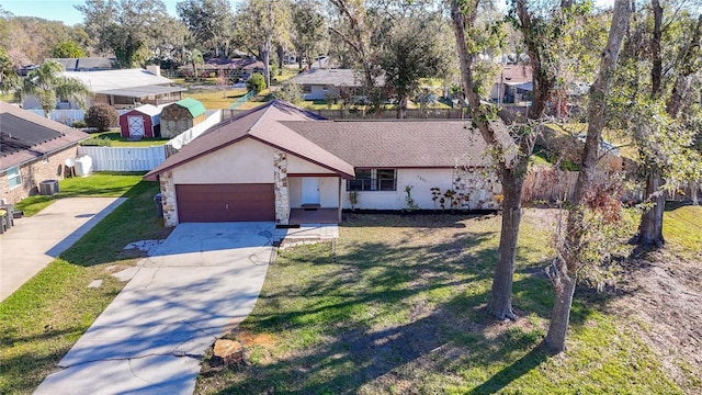 view of front of home with central AC unit and a front lawn