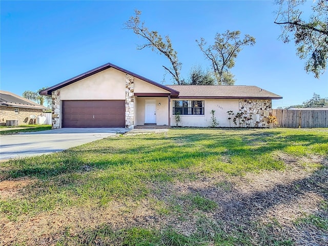 ranch-style house featuring a front yard and a garage