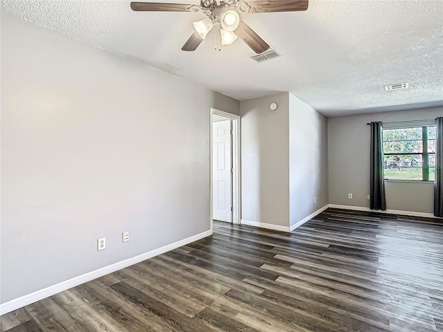 unfurnished room with a textured ceiling, ceiling fan, and dark wood-type flooring