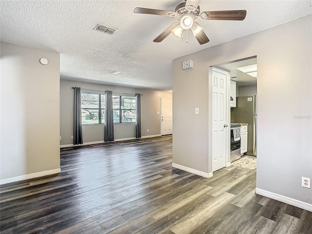 spare room featuring ceiling fan, dark hardwood / wood-style flooring, and a textured ceiling