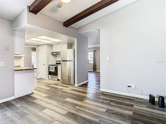 kitchen featuring stainless steel appliances, lofted ceiling with beams, wooden counters, dark hardwood / wood-style floors, and white cabinets