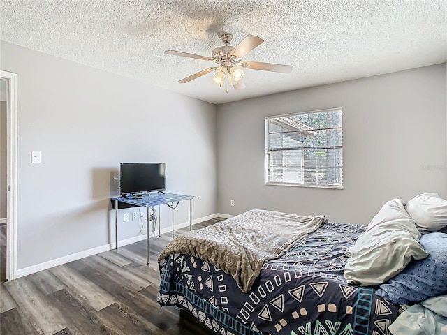 bedroom featuring hardwood / wood-style floors, a textured ceiling, and ceiling fan