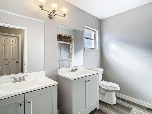 bathroom featuring toilet, vanity, and hardwood / wood-style flooring