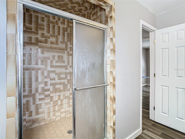 bathroom featuring hardwood / wood-style floors and walk in shower