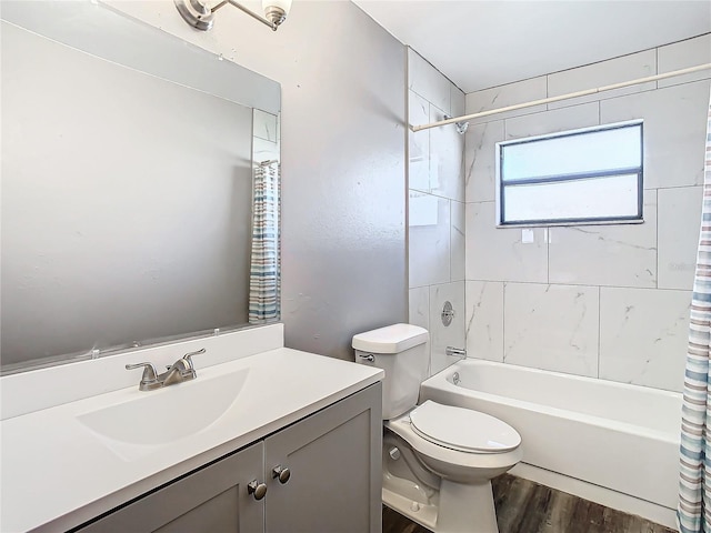 full bathroom with hardwood / wood-style flooring, vanity, toilet, and shower / tub combo with curtain