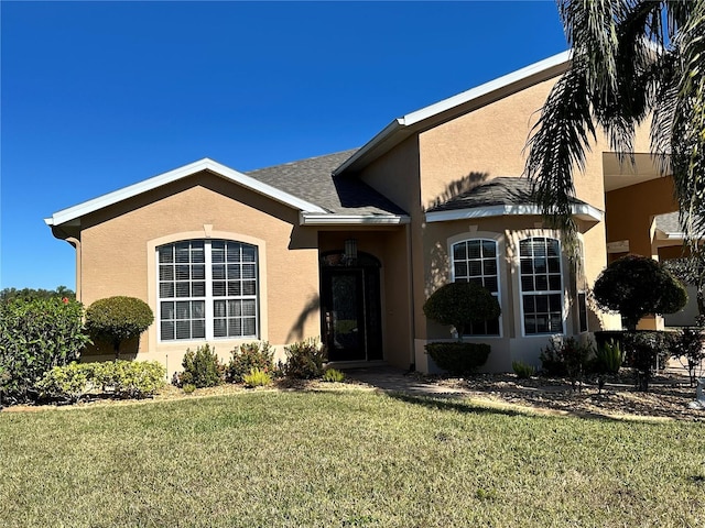 ranch-style home with a front lawn