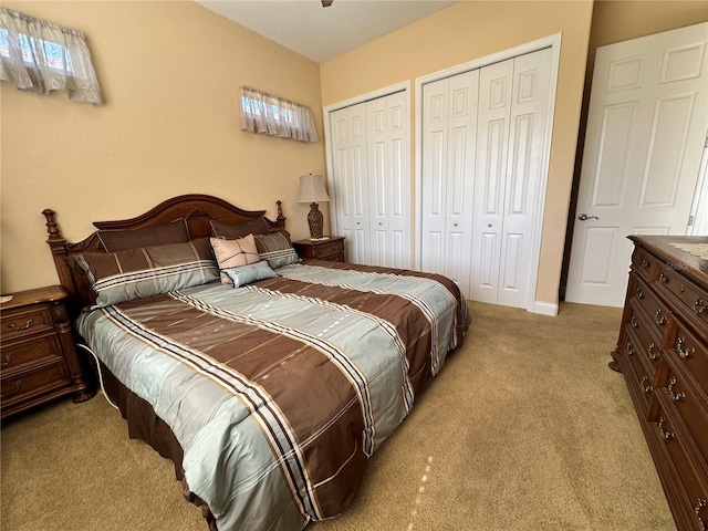 carpeted bedroom featuring multiple closets