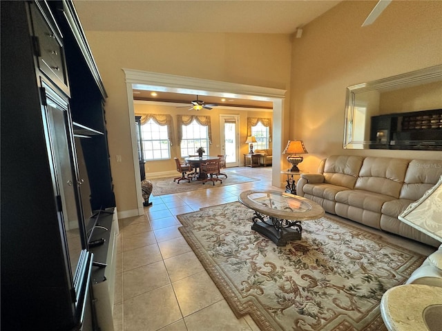 tiled living room featuring ceiling fan and vaulted ceiling