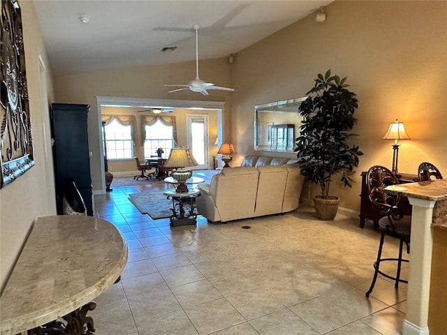 living room featuring light tile patterned flooring, vaulted ceiling, and ceiling fan