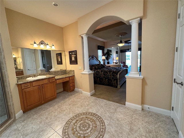 bathroom with tile patterned flooring, ceiling fan, vanity, and decorative columns