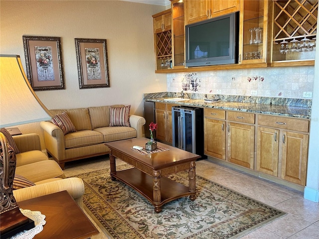 interior space featuring beverage cooler, indoor wet bar, and light tile patterned floors