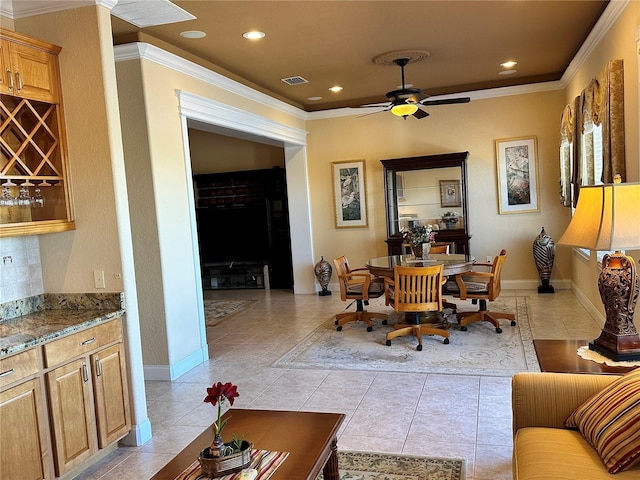 living room with crown molding, ceiling fan, and light tile patterned floors