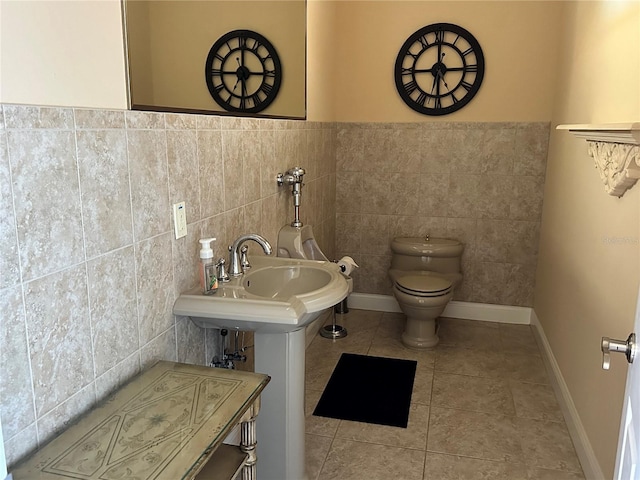 bathroom with tile patterned flooring, tile walls, and toilet