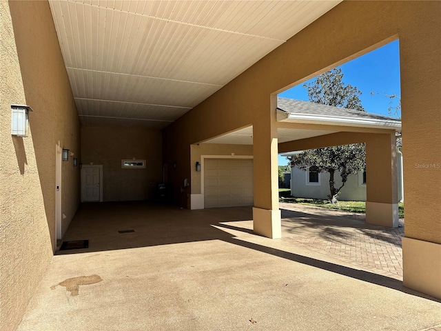 view of patio / terrace featuring a garage and a carport