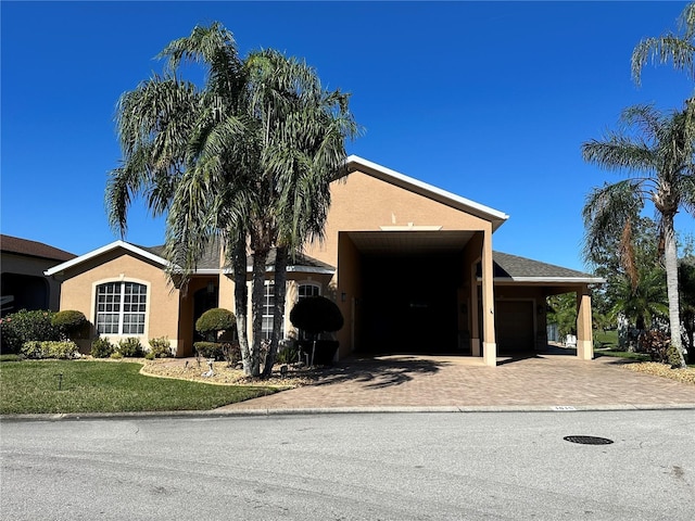 view of front of house with a front lawn and a carport