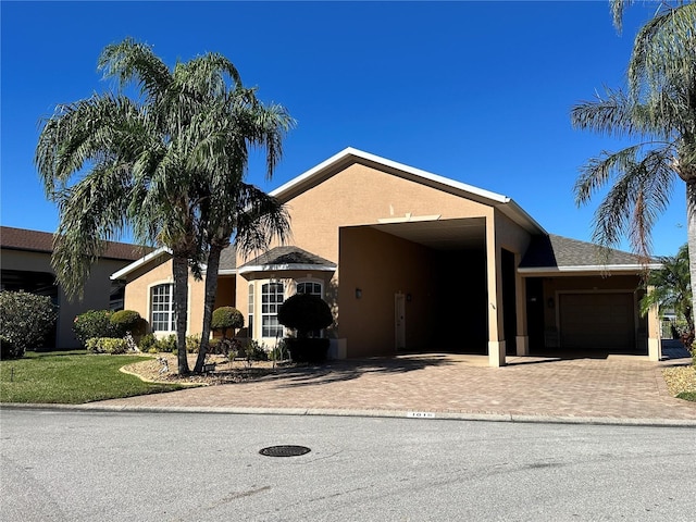 ranch-style house featuring a garage and a carport