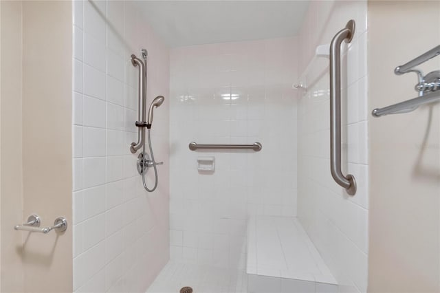 bathroom with a tile shower