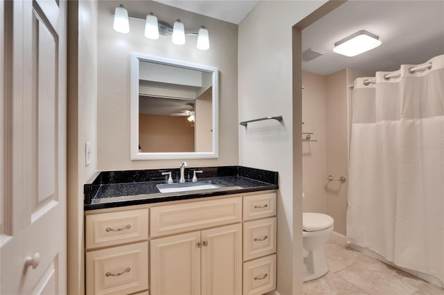 bathroom featuring a shower with shower curtain, visible vents, vanity, and toilet