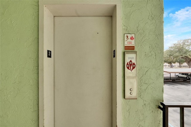 room details featuring elevator and a textured wall