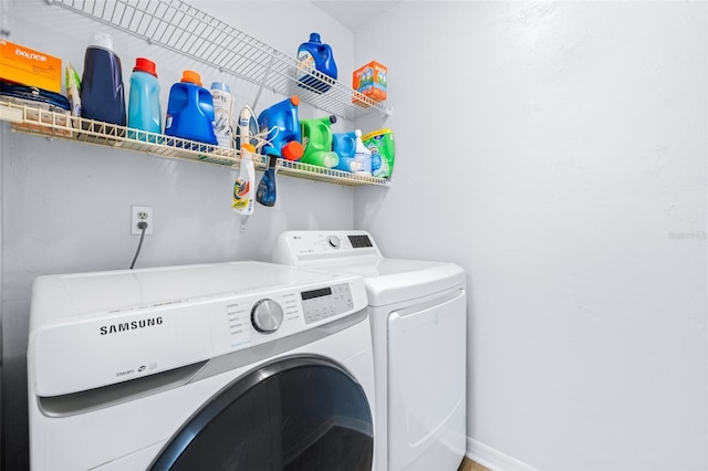 clothes washing area with independent washer and dryer