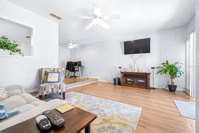 living room featuring hardwood / wood-style flooring and ceiling fan