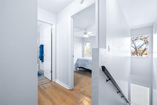 corridor with light hardwood / wood-style flooring