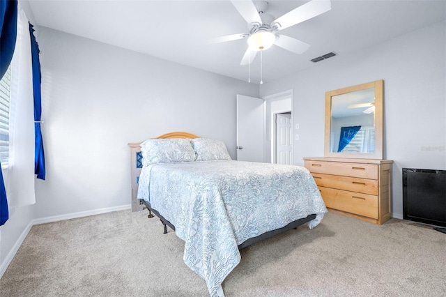 bedroom featuring light carpet and ceiling fan