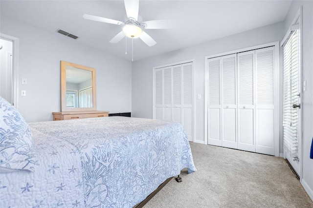 bedroom featuring carpet flooring, multiple closets, ceiling fan, and multiple windows