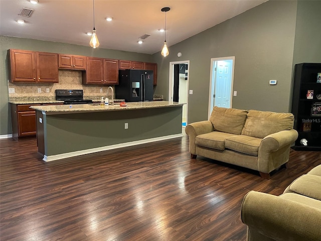 kitchen featuring a center island with sink, black appliances, and hanging light fixtures