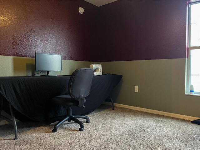 carpeted home office featuring vaulted ceiling