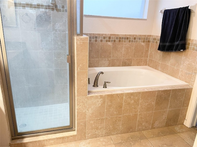 bathroom featuring shower with separate bathtub