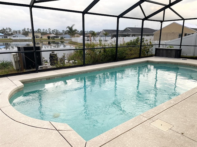 view of pool with a lanai and a water view