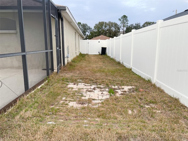 view of yard featuring glass enclosure