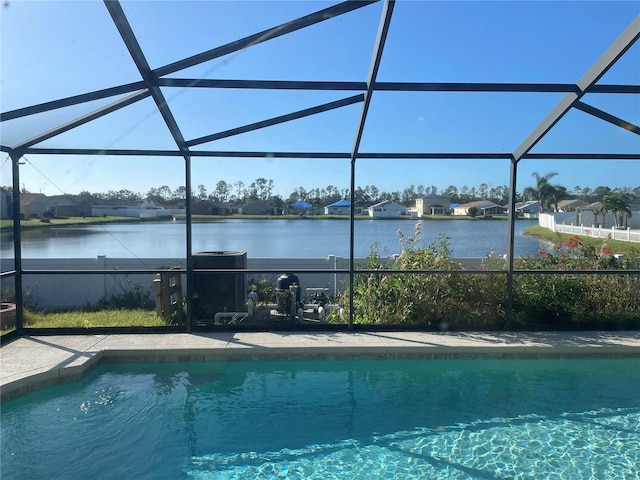 pool with a residential view, glass enclosure, and a water view