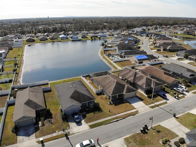 birds eye view of property with a residential view and a water view