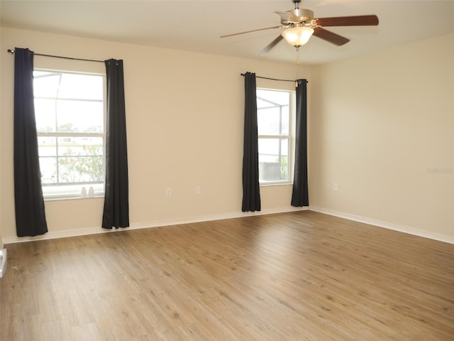 unfurnished room with light wood-type flooring, ceiling fan, and a healthy amount of sunlight