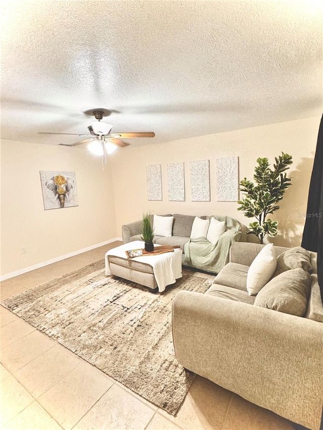 living room featuring a textured ceiling, tile patterned floors, and ceiling fan