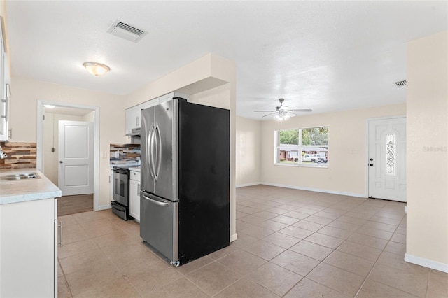 kitchen featuring stainless steel fridge, ceiling fan, sink, electric range, and white cabinets