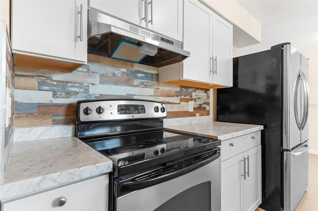 kitchen with decorative backsplash, appliances with stainless steel finishes, and white cabinetry