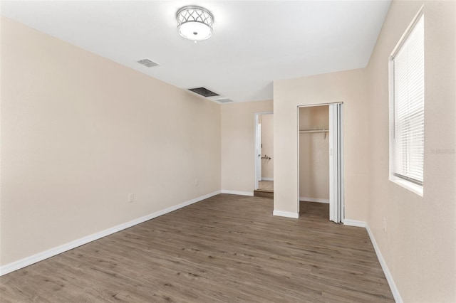 unfurnished bedroom featuring dark wood-type flooring