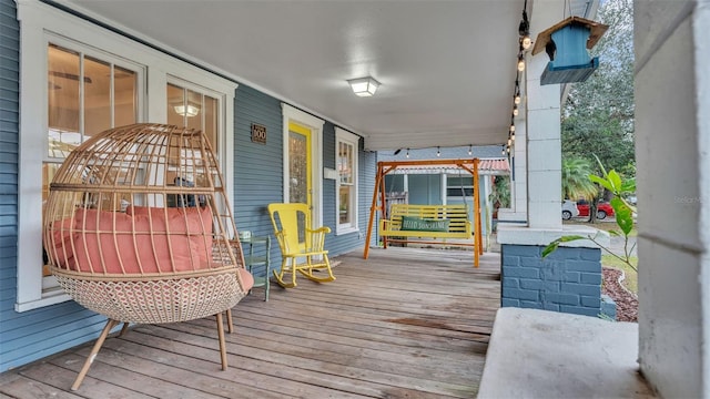 wooden terrace featuring covered porch