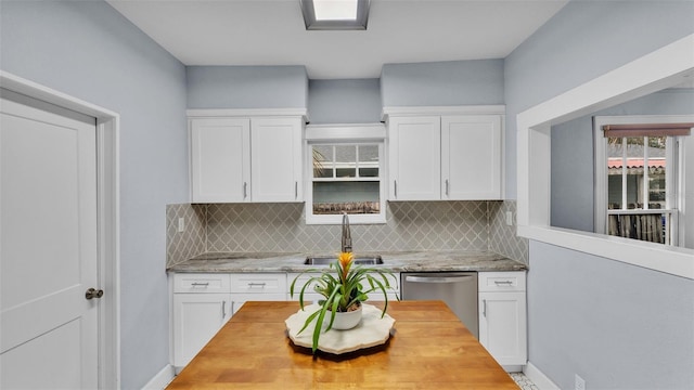 kitchen with white cabinetry, sink, and stainless steel dishwasher