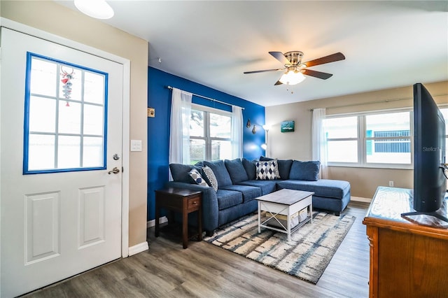 living room featuring hardwood / wood-style flooring and ceiling fan