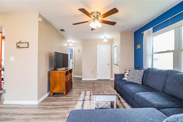 living room featuring ceiling fan and light wood-type flooring