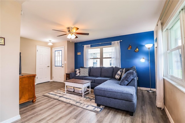 living room with wood-type flooring and ceiling fan