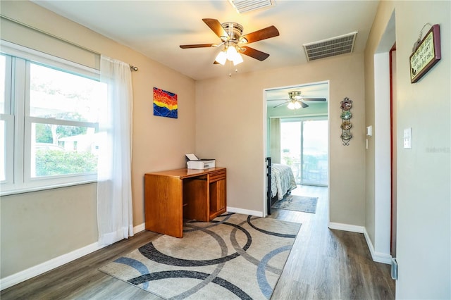 doorway to outside with ceiling fan and dark wood-type flooring