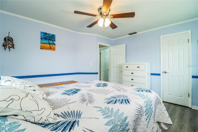 bedroom with ceiling fan, crown molding, and dark hardwood / wood-style floors