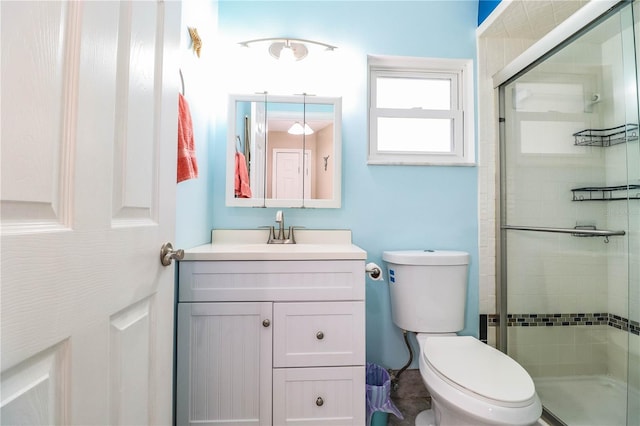 bathroom with toilet, an enclosed shower, and vanity