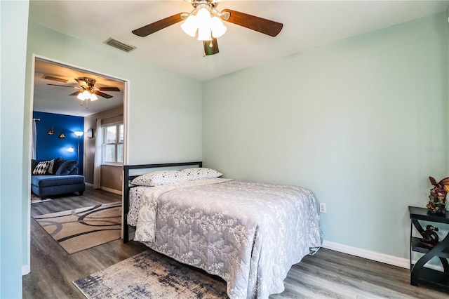 bedroom featuring ceiling fan and dark hardwood / wood-style flooring